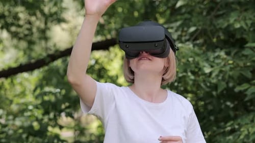 Woman Experiencing Virtual Reality Outdoors with VR Headset