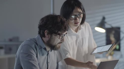 Office Colleagues Discussing Work in Evening