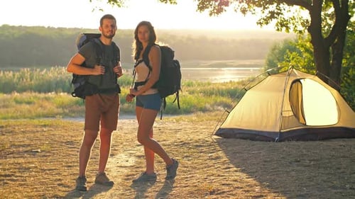 Couple Camping Near Tent at Sunset