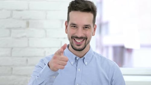Portrait of Cheerful Man Pointing at the Camera