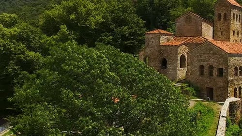 Tourists Walking Through Ancient Ruins of Georgia, Green Mountains, Tourism