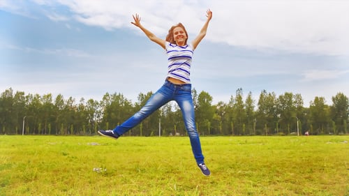 Teenagers Running Through the Meadow