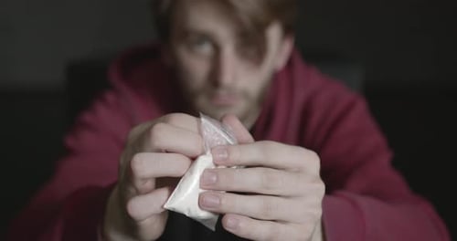 Young Addicted Man with Cocain Packet Sitting Alone