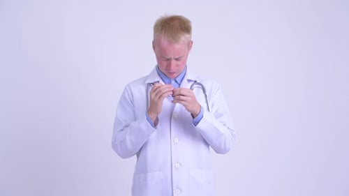 Blonde Doctor Massaging Temples, Eye Strain, Headache