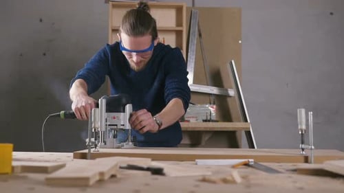 Man Routing Wood in Workshop with Precision