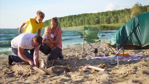 Making a Fire During Camping Trip in the Countryside