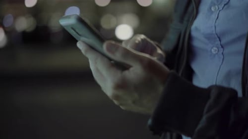 Using Smartphone At Night In City