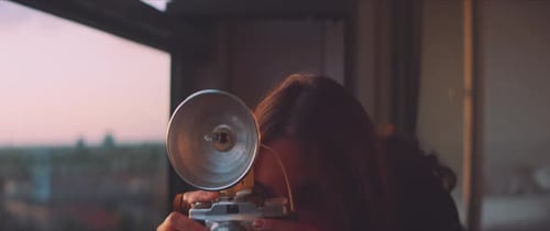 Woman photographer taking a picture close up