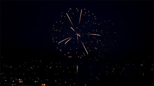 Fireworks Exploding Over the City at Night