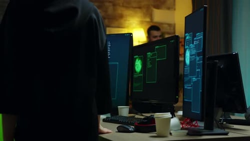 Busy Coders Work on Computers in an Office