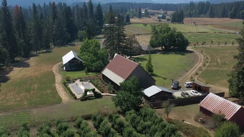 Aerial orbit of an old barn wedding venue in a rural region of Washington state.