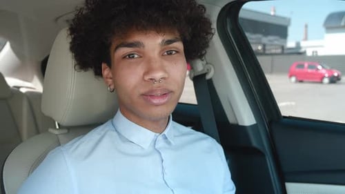 Smiling Young Adult Talking in Car