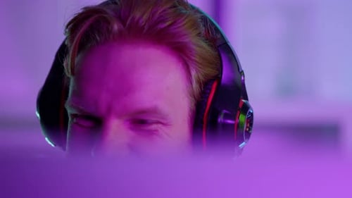 Intense Gamer Wearing Headset Playing Video Games