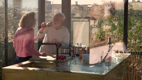 Senior Couple Cooking Together in a Bright Kitchen