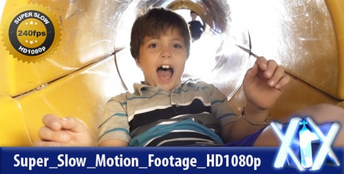 Boy Having Fun Sliding Down Yellow Tunnel Slide