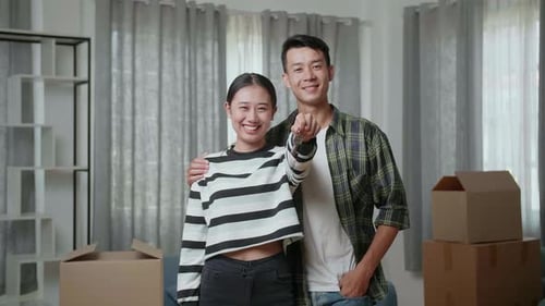 Happy Couple in New Home with Keys
