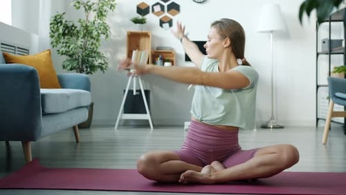 Woman Doing Yoga In Her Living Room
