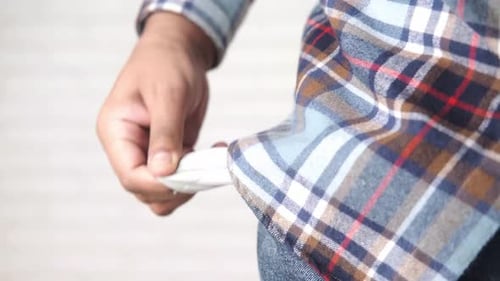 Young Man Shows Empty Pant Pocket with Copy Space