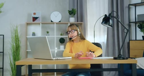 Cute Girl Using Tablet with Laptop and Headset