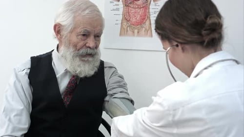 Doctor Measuring Blood Pressure of Male Patient