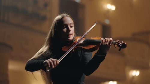 Classic Music Concert in Philharmonic Hall Young Female Violinist is Playing Fiddle in Dark