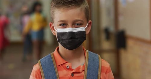 Child Wearing Mask in School Hallway