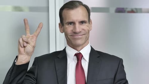 Victory Sign By Businessman