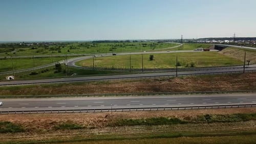 Flying Along the Modern Highway Road Intersection on Rural Landscape
