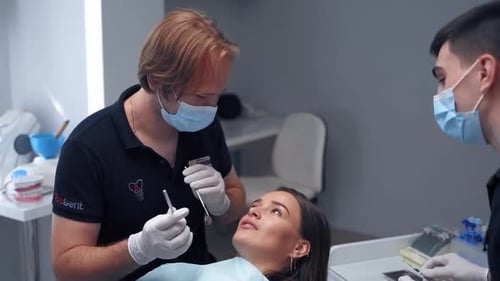 Stomatology treatment in dentistry. Beautiful young woman having dental treatment at dentist office