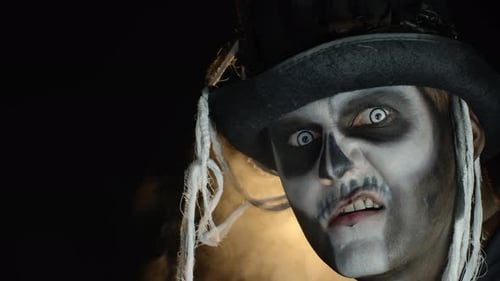 Man with Skull Face Paint Smirks Sinisterly