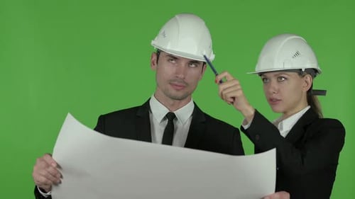 Happy Female Engineer Explaining Blueprint To Male Engineer, Chroma Key