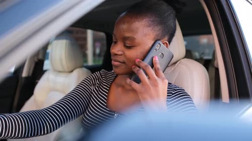 Woman Chatting on Smartphone Inside Car
