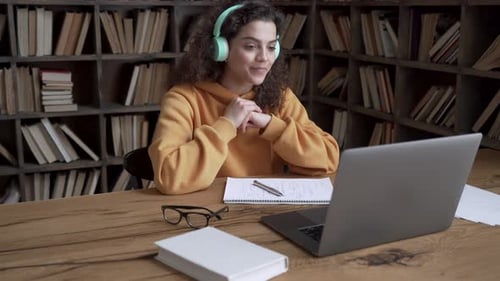 Woman Attending Online Class in Library Setting