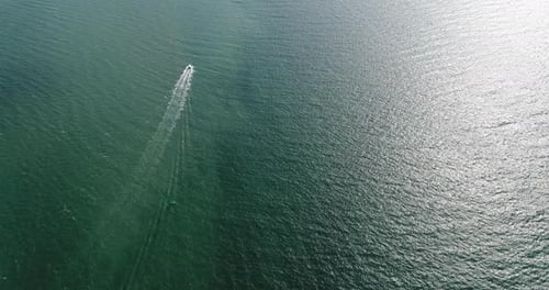 Aerial view of speed boats on the sea near beach city