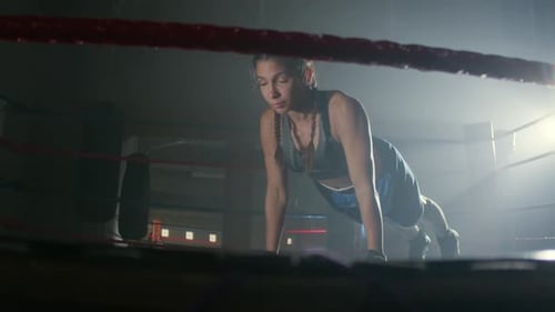 Female Boxer Doing Push Ups in Boxing Ring