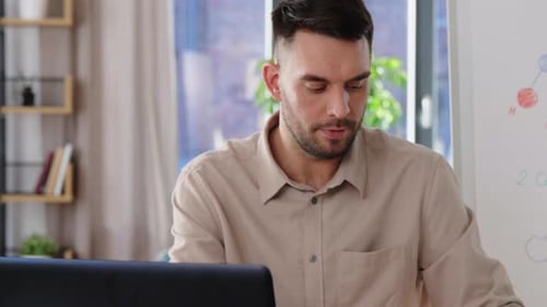 Bearded Adult Explains a Molecule Model At Home