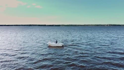 Aerial Drone Video Fly Over of Small Motor Boat Coasting Threw the Bay Blue Water Into Harbor on a