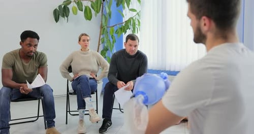 Adults Learning CPR Techniques in Bright Classroom