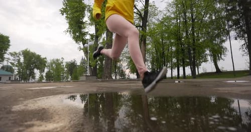 Young Woman Running In The Park