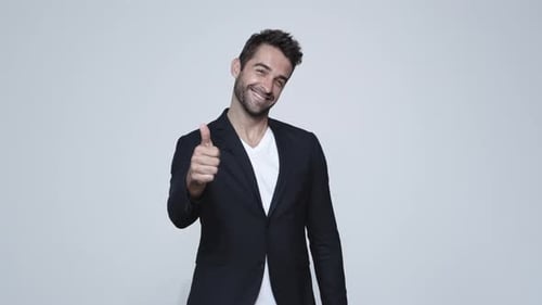 Handsome Man Buttons Blazer and Gives Thumbs Up