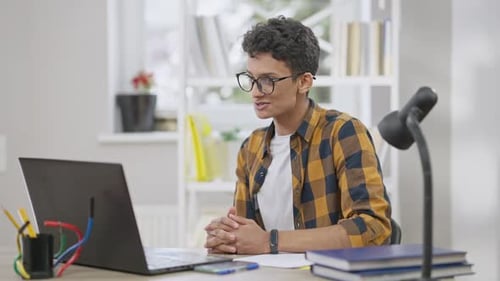 Young Man Video Conferencing at Desk Indoors