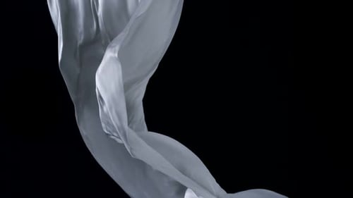 Light Grey Fabric Flowing Against Black Background