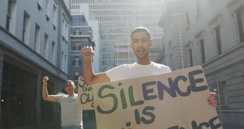 Young Adults Protesting with Signs in City