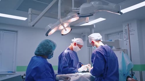 Surgeons Performing Operation in Brightly Lit Operating Room