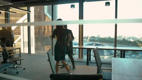 Handsome Man and Sexy Woman in Business Office Dancing After Winning