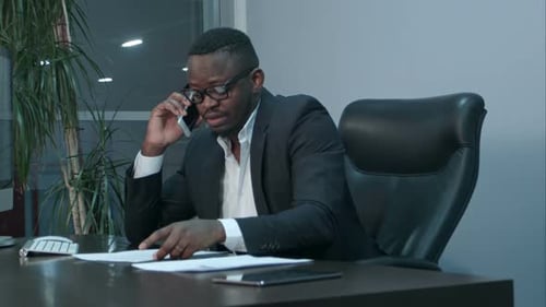 Adult Man Speaking on Mobile Phone in Office