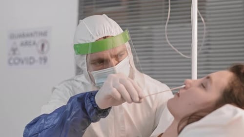 Doctor Collecting Fluid Sample for Testing