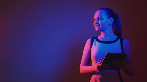 Blonde Woman Smiling Holding Tablet