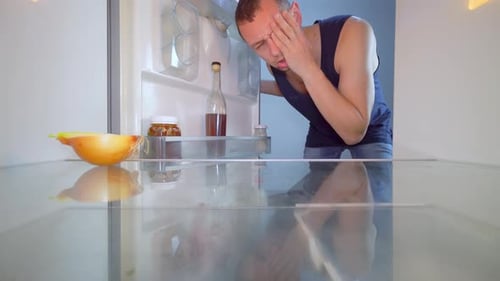 Man Opens Nearly Empty Refrigerator, Disappointed