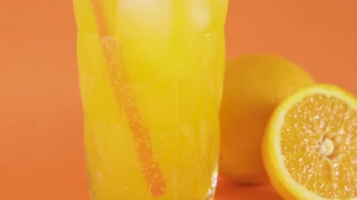 Glass of Orange Juice with Ice and Fruit